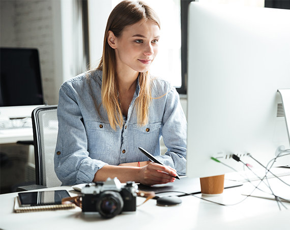 Young woman sitting all day at a desk in an office with poor circulation.